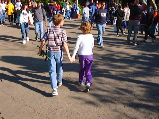 Children at Disney World holding hands
